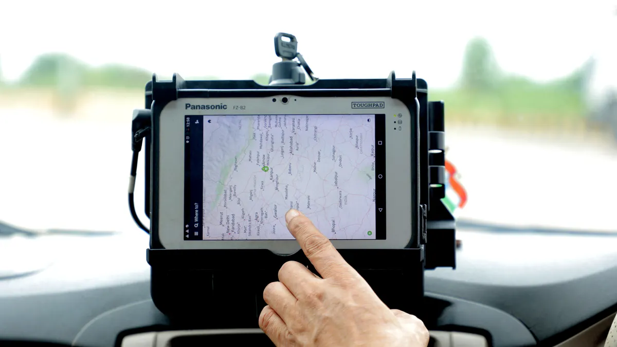 How to Export Rank Tracker Data for Clients and Dashboards — Hand Touching GPS Tracker in Car